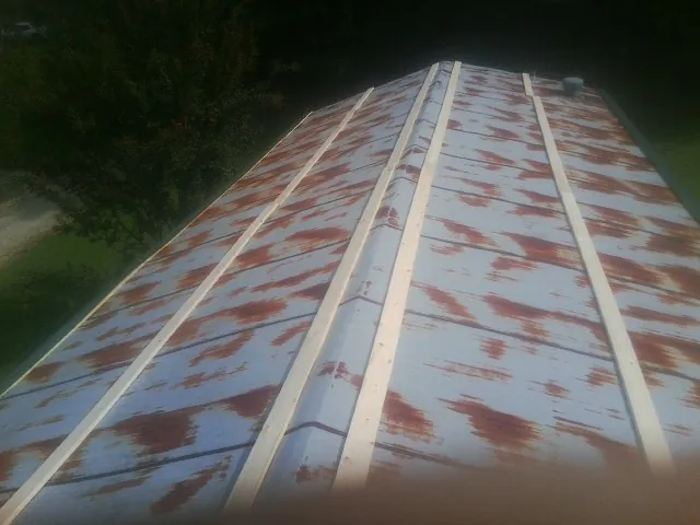 Rusted metal roof panels with new wood purlins before replacement — Storm Damage Roof Repair in Mount Tremper by Roofing Brothers